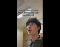 Guy in black and white shirt comes through door