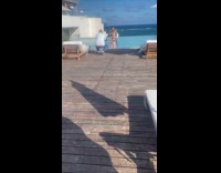 Woman bikini hold sip drink pool railings