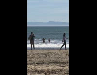 Girl tells her boyfriend to record a video of her walking on the beach, so natural