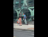 Black hat girl sidewalk guy on scooter 