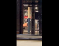 Shirtless man decline push ups at subway station