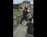 Tourist leaning tower of pisa pose 