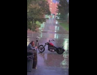 Man photo shoot motorcycle rain sidewalk music