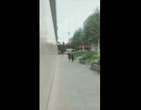 Cameraman follow man maroon suit ride scooter