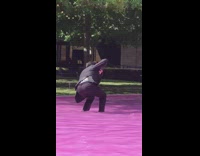 Girl squat on pink pool cameraman suit