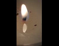 Soot floating on candle wax