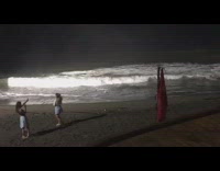 Girl dances on beach to music 