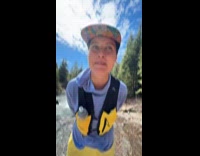 Man drinking from girlfriends hiking vest