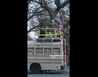 Guy wearing green jacket dances on bus