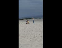 Woman white hat long blue jeans photo shoot beach Part 3