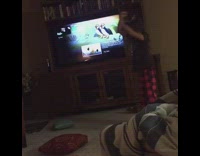 Little girl dances in her living room with a hula hoop, does backflip but fails