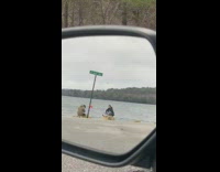 Long haired guy sit shore reflection skateboard