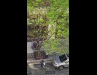 Grandpa helps little girl ride pink bicycle 