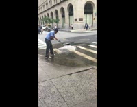 Guy in blue trying to push huge puddle of water away with broom fail