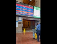 Man walks with props legs on bin