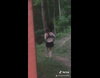 Girl runs towards black bear turns around 