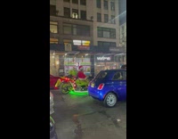 Man in the grinch costume rides motorcycle 