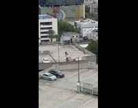 Two women in black dress tiktok dance rooftop