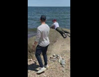 Girl white shirt mermaid pose rock beach