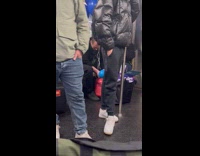 Guy blow balloons with helium tank subway