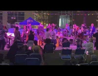 People dance to music man balances basketball