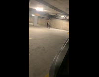 Blonde Lady in Black Takes Photos in Parking Structure 