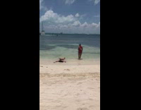 Girl lays down on beach shore 