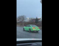 Green car covered with Chrismas lights road