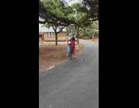 Woman tries to ride bike with bunch of luggage 