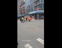 Man biking passed by collapsed building scaffolding 