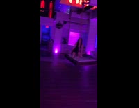 Woman in Black Dress Swings on Seat for Photo