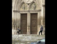 Woman in black leather skirt dance in front of cathedral