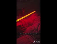 Cat scared of red light saber falls off bed 