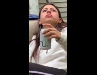 Woman stares into the sky quietly after eating a very spicy hot wing