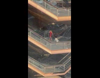 Woman red dress photoshoot third floor stairs