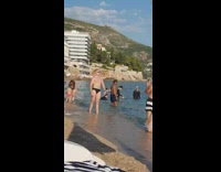 Bald guy black brief stand pose beach