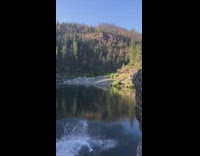 Two guys backflip front flip rock lake 