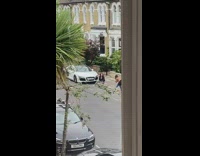 Girl black jacket sit gutter white car