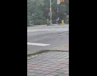 Guy bikes with skeleton behind him 