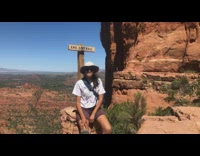 Woman sit rock peace sign across pictorial