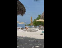 Woman beige bikini attempts to do a handstand failed