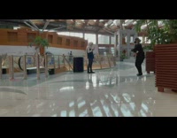 Woman staff black suit dance in airport