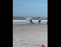 Woman mermaid costume sits on inflatable seashell Part 1