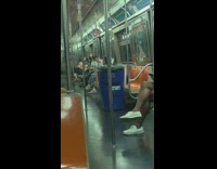 Blue recycling bin inside moving train