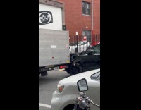 Truck runs over car parked on street