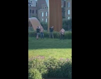 Shirtless guy black chaps pants grass park 