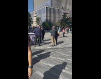 Woman poses with a shirtless man on a handstand at the park