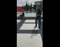 Girl sits on edge of fountain for photo 