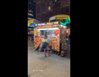 Person wearing pigeon costume in front of food truck