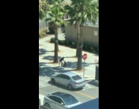 Man DJ video shoot on the sidewalk